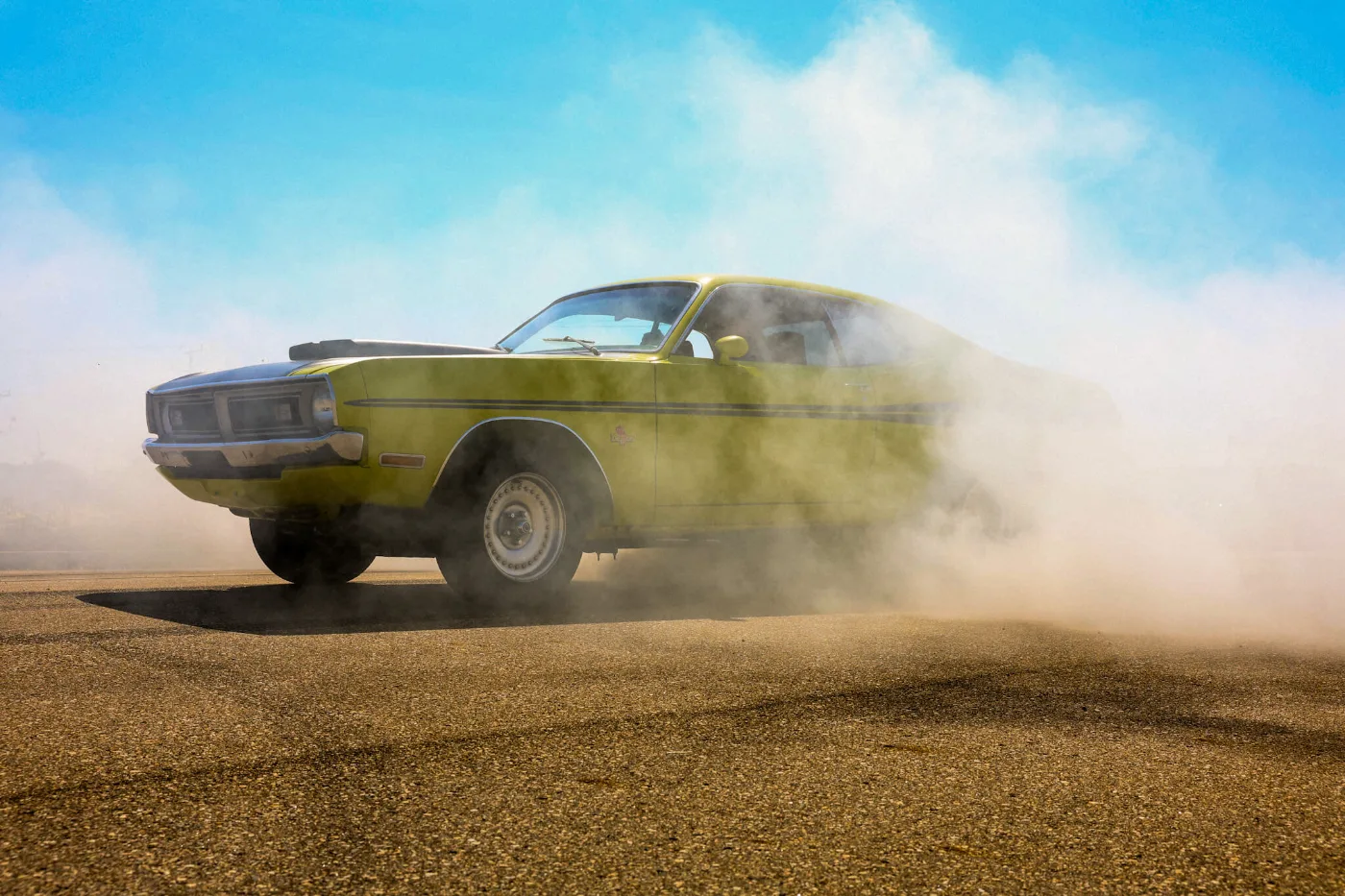 Yellow Dodge Demon laying down a burnout after its NCC Classic restoration