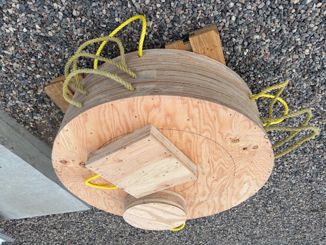 Wooden outrigger pads on a gravel lot